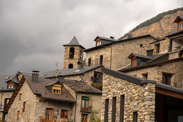 Detail shot of the roofs of some stone buildings with slate roofs in the tourist village of Cerler in Huesca on a cloudy day.