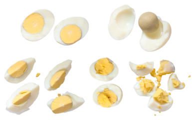 Set of hard boiled egg cut in halves and chopped isolated on white background 