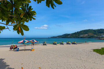 Patong Beach Phuket Thailand nice white sandy beach clear blue and turquoise waters and lovely blue skies with Palms tree