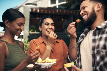 How yummy are these. a diverse group of friends standing outside a restaurant and bonding while enjoying their takeaway.