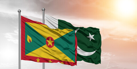 Flags of Pakistan and Grenada friendship flag waving on the sky with beautiful Background.