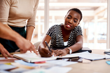 Creativity solves problems faster and easier. a young businesswoman working with her colleagues in an office.