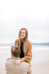 Fototapeta na wymiar A magical moment captured: A couple gets engaged on a California beach