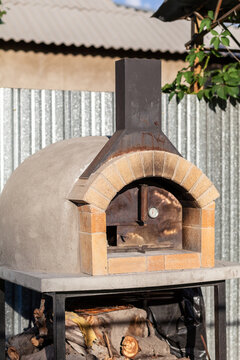 Cooking real pizza in a brick oven. Wood and fire are burning in the stove.