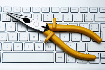 snipe nose pliers tool and computer keyboard