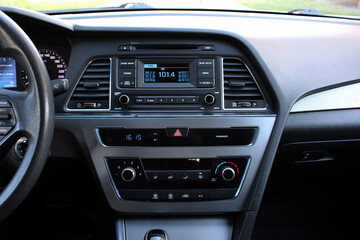 Fototapeta na wymiar Car detailing. Car multimedia and climate control. Modern car interior details. Control temperature and security with car display. Home temperature, safety and environment.