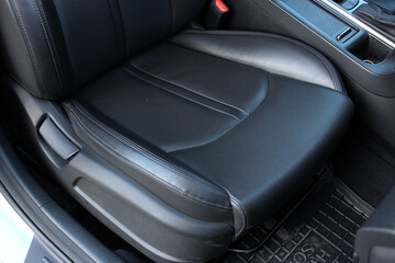Modern luxury car black leather with alcantara interior. Part of black leather car seat. Interior...
