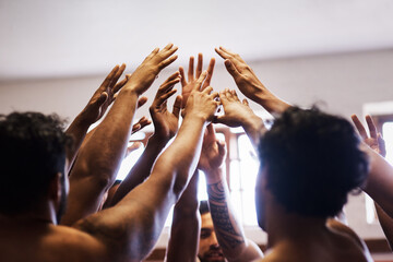 One team, one rugby dream. a group of young rugby players joining their hands in solidarity in the locker room.
