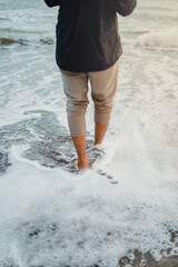 Walking at the beach barefoot at Sunset in Yogyakarta Province