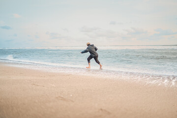 A man playing with the waves on the Samas Beach in Bantul Regency.