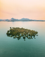 Remote island with turquoise water  in Karimun Regency. Mengke island from birds eye.
