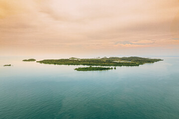 Remote island with turquoise water  in Karimun Regency. Asam island from birds eye.