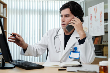 Fototapeta premium Doctor calling colleague to get advise on medical advice interpretation
