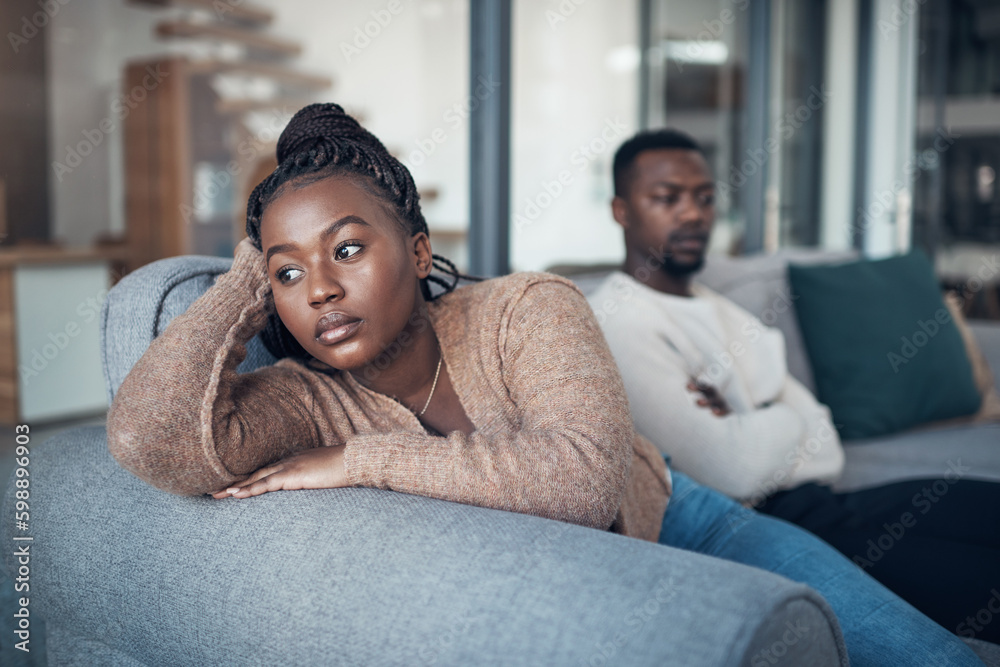 Poster I dont want to hear anything he has to say. a young couple sitting on the sofa and giving each other the silent treatment after an argument.