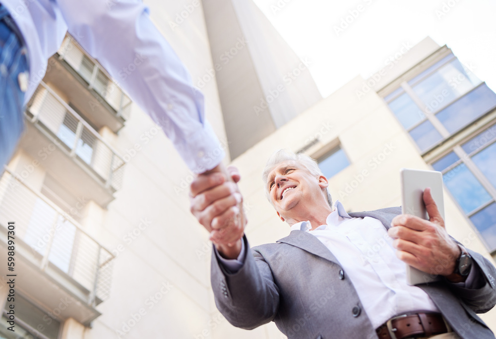 Poster Lets get this project started. Low angle shot of two businessmen standing outside on the balcony together and shaking hands.