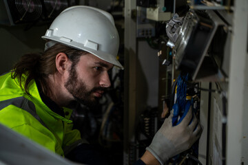 Engineer inspect robotic arm in workshop,Checking quality of workpieces manufacturing industry technology.