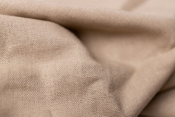 Natural linen fabric texture. Rough crumpled burlap background. Selective focus