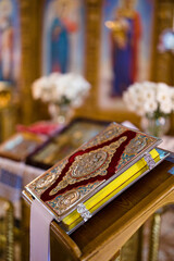 Closeup view to Holy bible on lectern during a wedding ceremony in an Orthodox church.