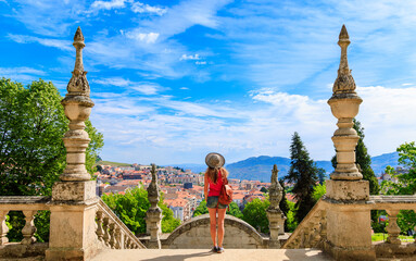 Woman tourist contempling panoramic view of Lamego city- Nossa Senhora dos Remedios in Portugal- distric of Viseu - obrazy, fototapety, plakaty