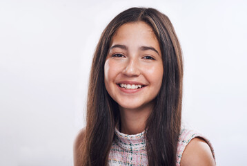 A smile a day keep the blues away. Cropped portrait of an attractive teenage girl standing alone against a white background in the studio.