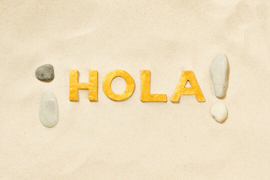 Hola! - Spanish greeting in the sand