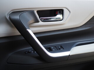 Inner door handle with lock unlock buttons. Inner car door panel.