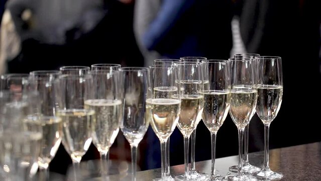 Kyiv, Ukraine - May 2023: Many glasses of champagne. Champagne is poured into glasses during a corporate party.