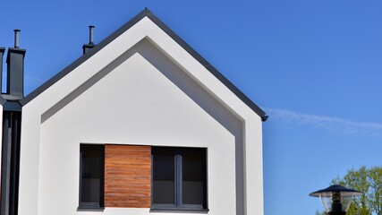 Terraced family homes in newly developed housing estate. The real estate market in the suburbs. New single family houses in a new development area. Residential homes with modern facade. 