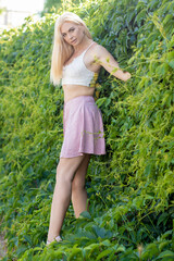 Happy young woman enjoying summer on green grass