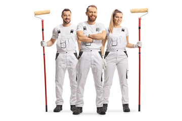 Male and female house painters in white overall pants smiling at camera