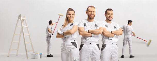Team of professional painters painting a wall