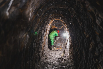 a miner drilling in a cave