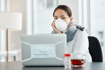 Its tough out there, keep your health strong. a masked young businesswoman working with hand sanitiser, a laptop and herbal tea at her desk.