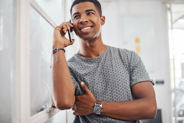 Hey man, how have you been. Portrait of a young businessman talking on a cellphone in an office.