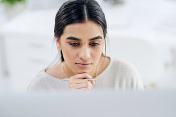 Focus always proceeds to success. High angle shot of a young businesswoman looking thoughtful while...