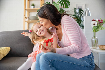 Smiling mother got a present from her cute little daughter