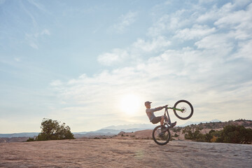 Fototapeta na wymiar Perfecting the art of biking. a young man out mountain biking during the day.