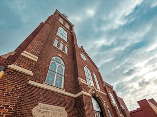 Historic Church Cathedral Reaching Towards the Sky. A majestic ornate old church stands tall against a dramatic blue sky. Set in the downtown historical district.
