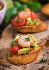 Homemade bruschetta with shrimps, avocado and cherry tomato - 598916902