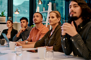 Theyre eager to learn from the speaker. a group of businesspeople listening to a presentation in the boardroom.