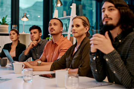 Theyre eager to learn from the speaker. a group of businesspeople listening to a presentation in the boardroom.