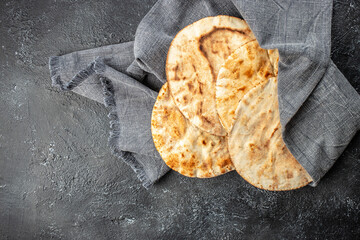 pita bread on a wooden board. Traditional Arabic cuisine. banner, menu, recipe place for text, top...