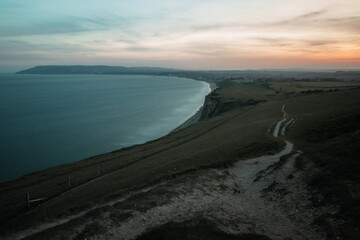 Fototapeta premium clifftop view of a sunset by the sea
