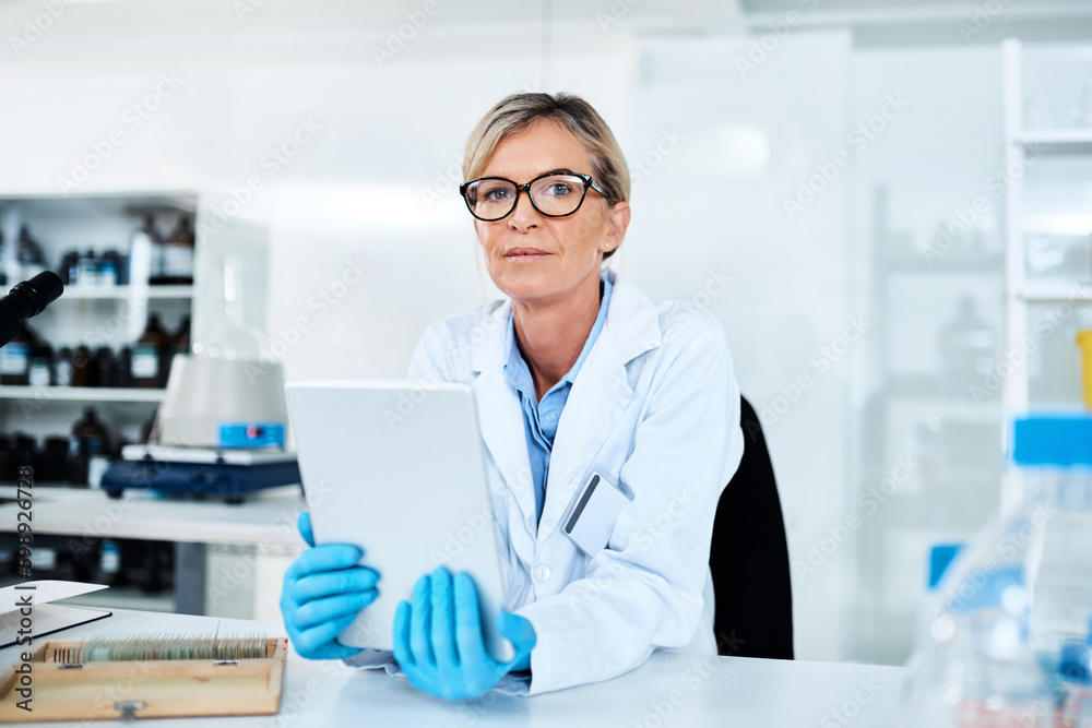 Poster Capturing data with utmost ease. Portrait of a mature scientist using a digital tablet in a lab.