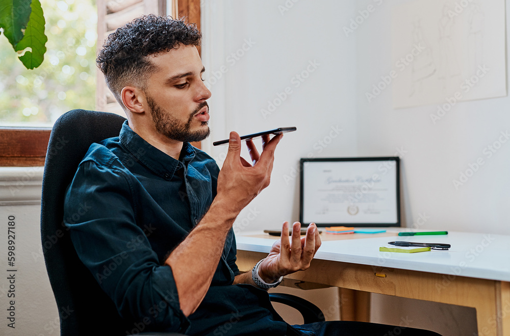 Poster im just calling with some feedback for you. a young businessman using a smartphone in a modern offic