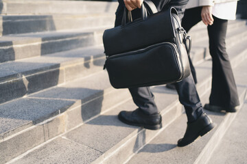 Leather briefcase for business meetings People going to work. - obrazy, fototapety, plakaty