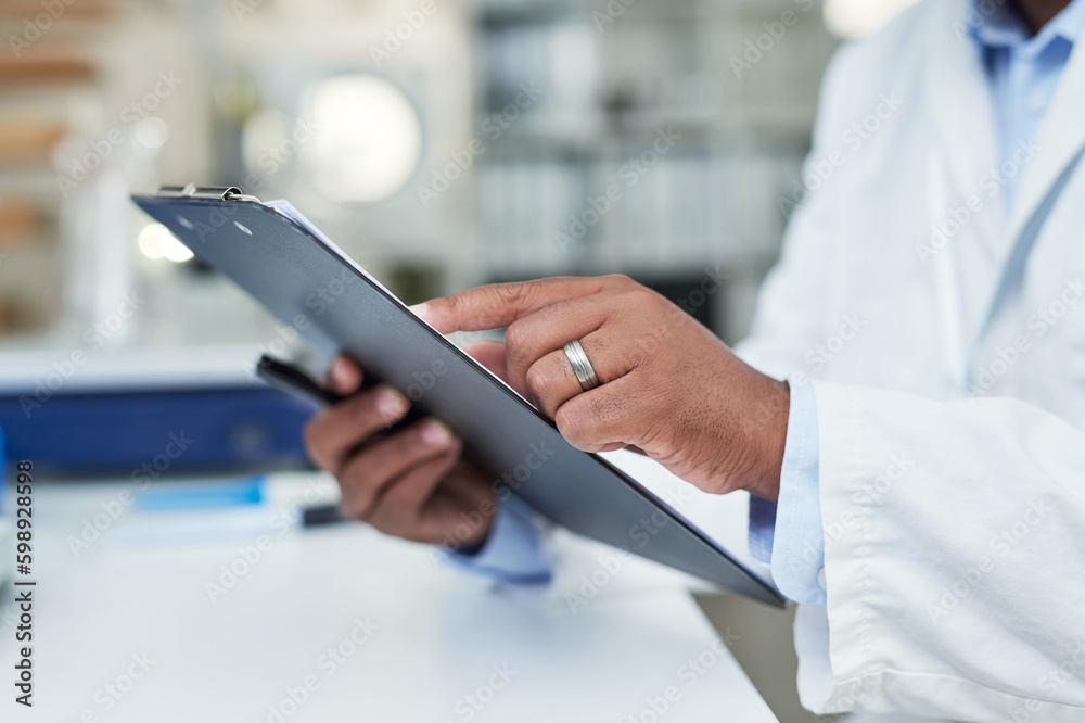 Poster taking a closer look at the records. closeup shot of an unrecognisable scientist holding a clipboard