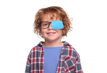 Smiling boy with eye patch on glasses against white background. Strabismus treatment