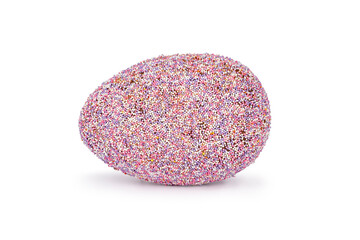 A rainbow sprinkled chocolate egg, laying on the side, isolated on a white background