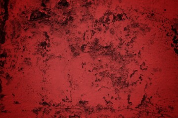 A textured background featuring deep red tones with a distressed, grunge appearance. The surface shows scratches and uneven patterns, creating a vintage feel.